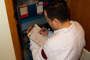 HVAC technician performing furnace maintenance