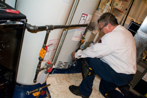 Plumber performing plumbing maintenance