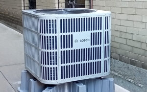 Energy-efficient bosch heat pump placed on concrete block.